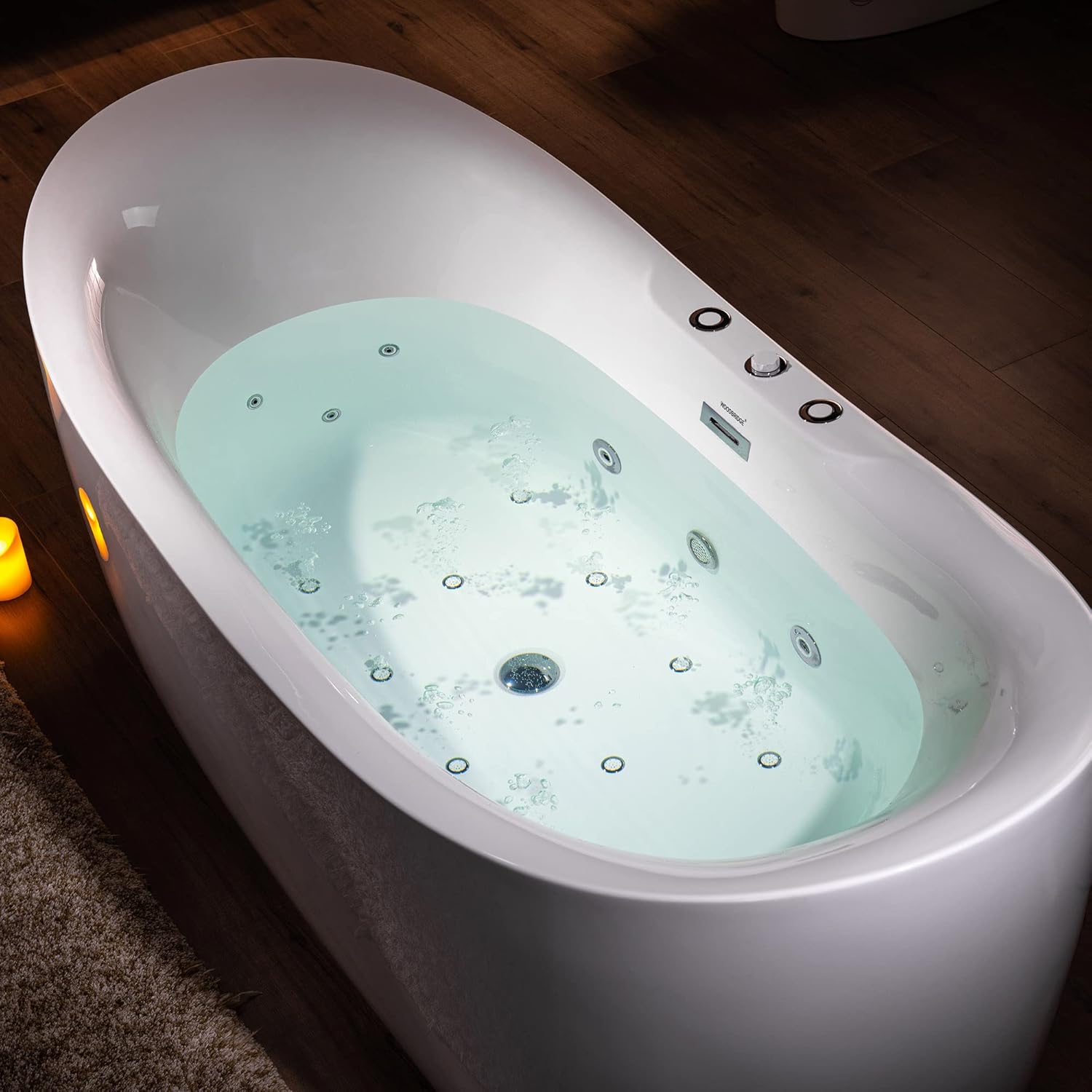 Bathtub interior illuminated by a chromotherapy light, creating a colorful water effect.