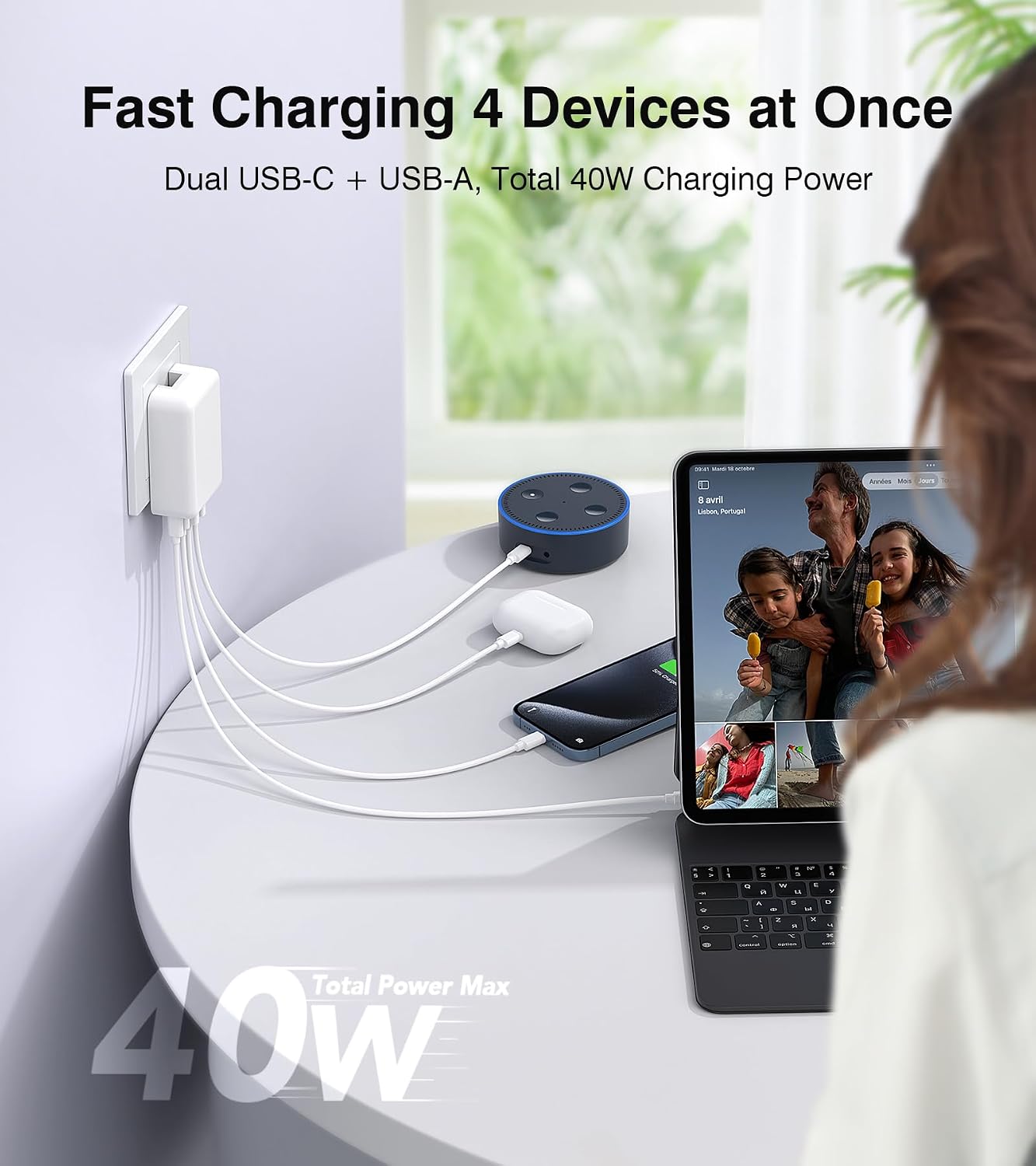 Image showing the charger connected to a wall outlet, simultaneously charging a tablet, smartphone, and earbuds.