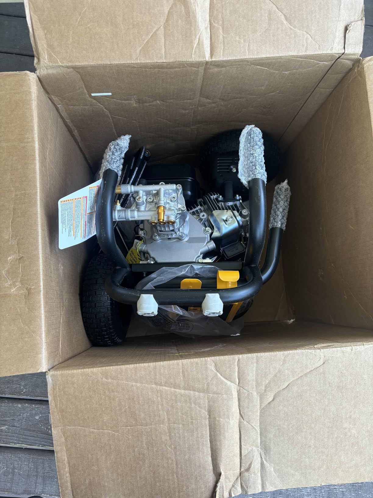 DeWalt DXPW3300-S on patio showing hose wrapped on frame and engine detail close-up