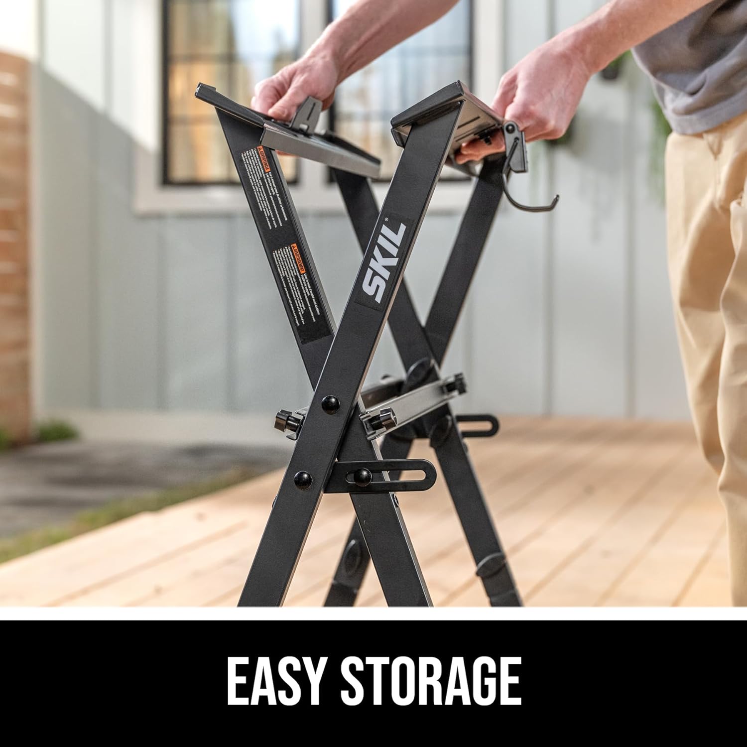 A person folding the SKIL workbench stand for easy storage