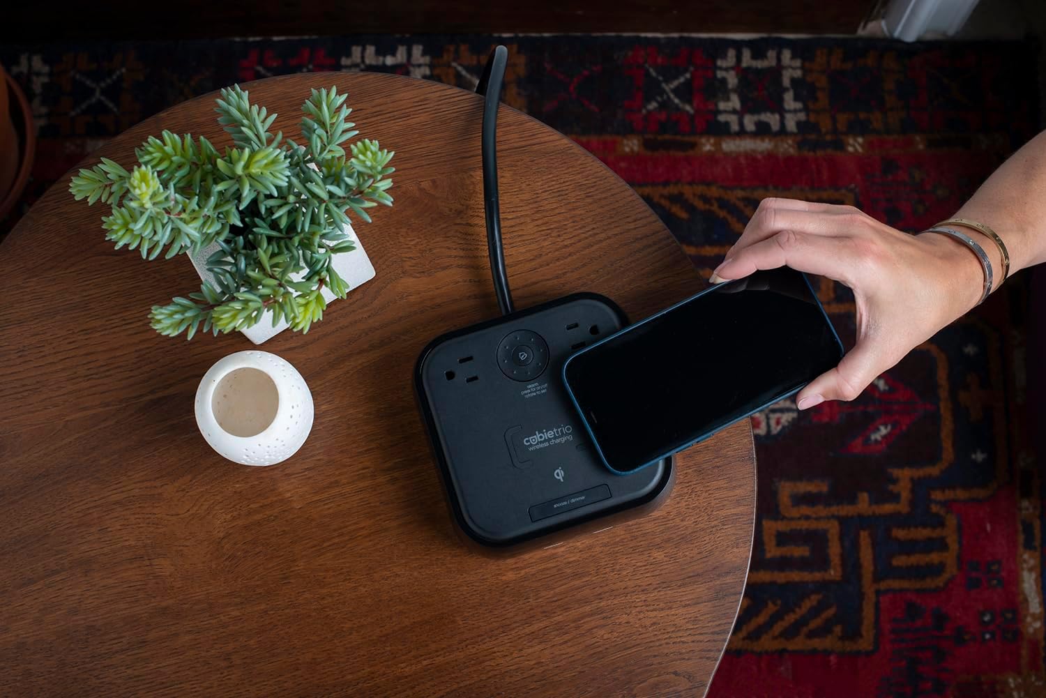 Hand placing phone on CubieTrio wireless charger