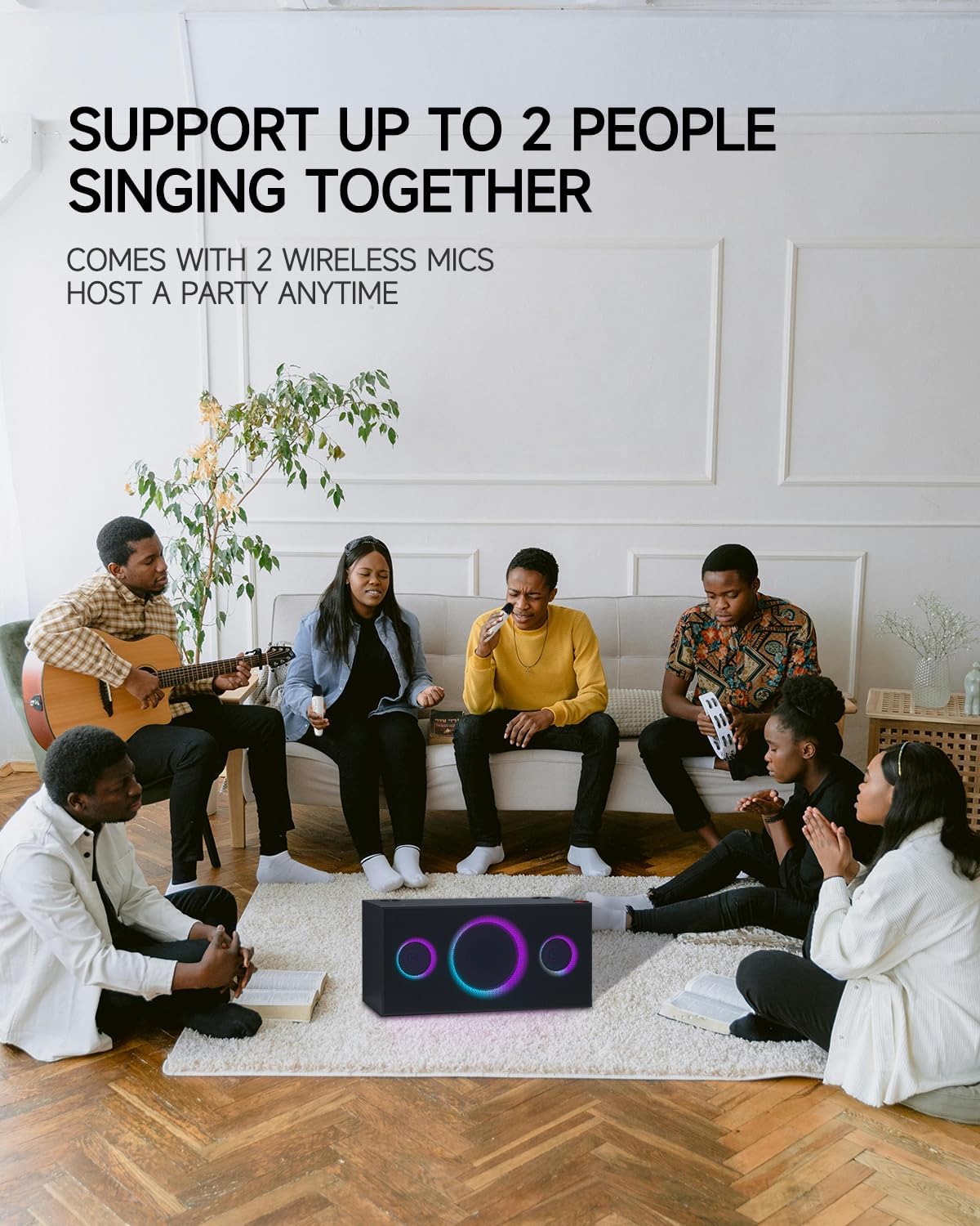A group of friends singing karaoke in a living room, with the PUREMIC S2B01 speaker connected to a TV, demonstrating its compatibility with Apple TV and Samsung TV.