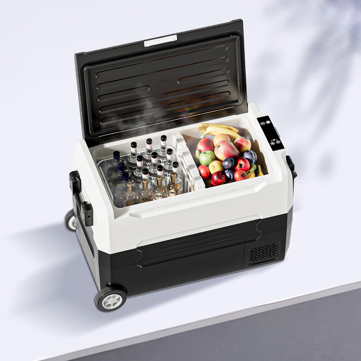 Interior view of TABU Portable Car Refrigerator showing dual zones with drinks and fruit