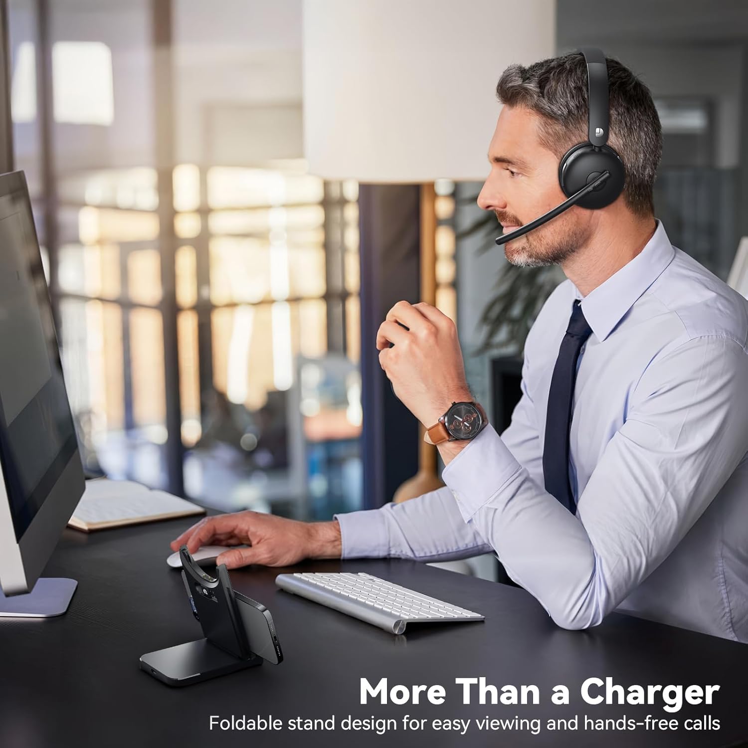 Man using Dytole Wireless Headset at a desk, with the charging dock functioning as a phone stand