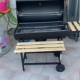 oneConcept Beefbutler - griglia a Carbone, griglia da Giardino, griglia Diretta e indiretta, 2 Ripiani in Legno, 4 Aperture di Ventilazione, Contenitore Rimovibile, Ruote per Trolley, Nero oneConcept Beefbutler - griglia a Carbone, griglia da Giardino, griglia Diretta e indiretta, 2 Ripiani in Legno, 4 Aperture di Ventilazione, Contenitore Rimovibile, Ruote per Trolley, Nero