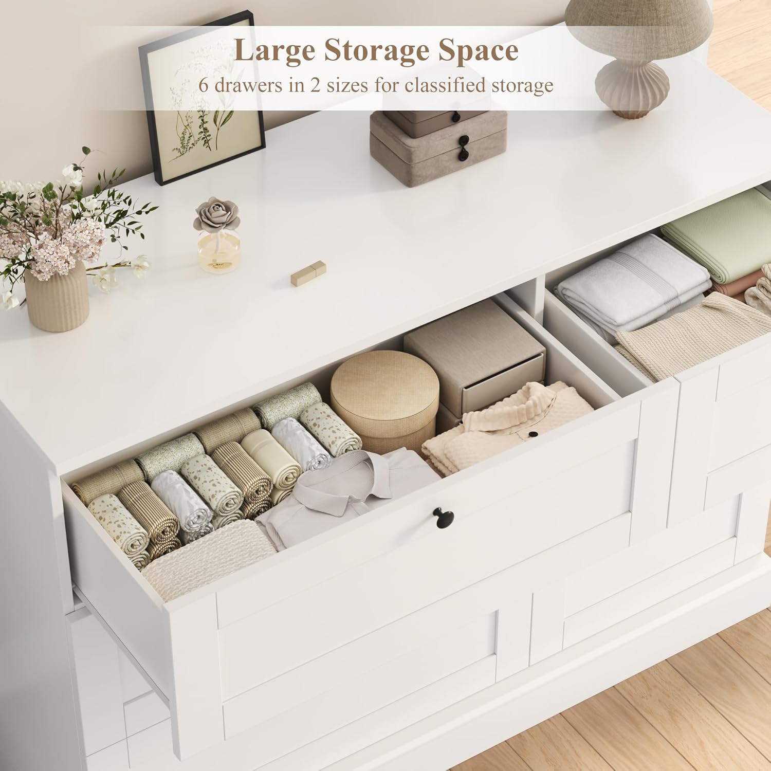 Image showing an open dresser drawer filled with folded clothes and organized items.