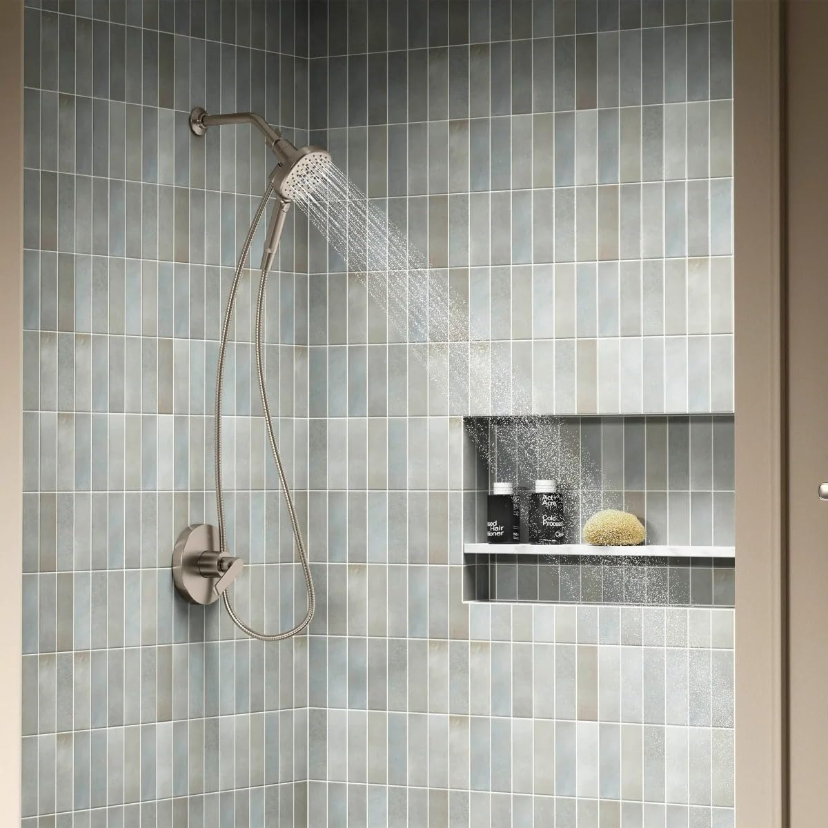 Installed Kohler Tellin Handshower in a modern shower with white tiled walls.