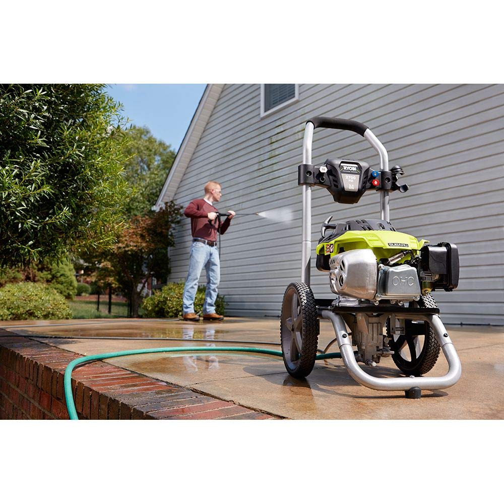 Person using RYOBI pressure washer to clean a patio