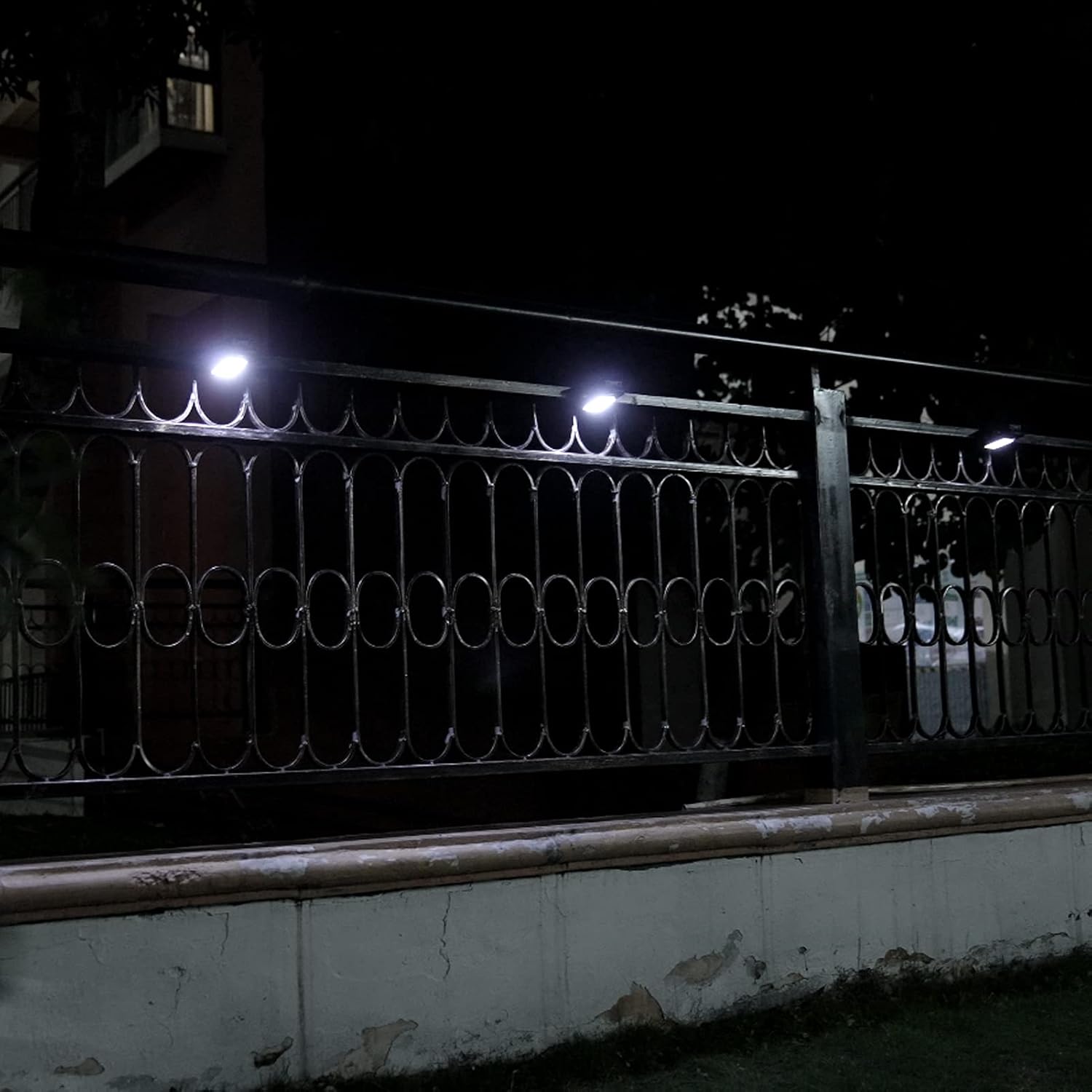 Solar lights installed on a fence at night