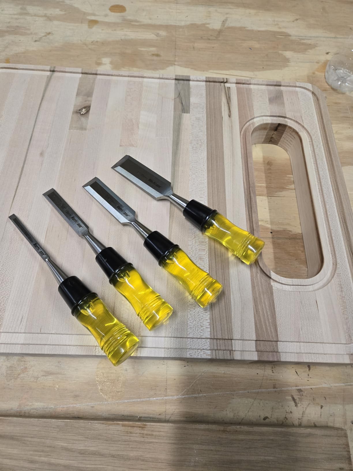 Set of wood chisels with wooden handles on a workbench