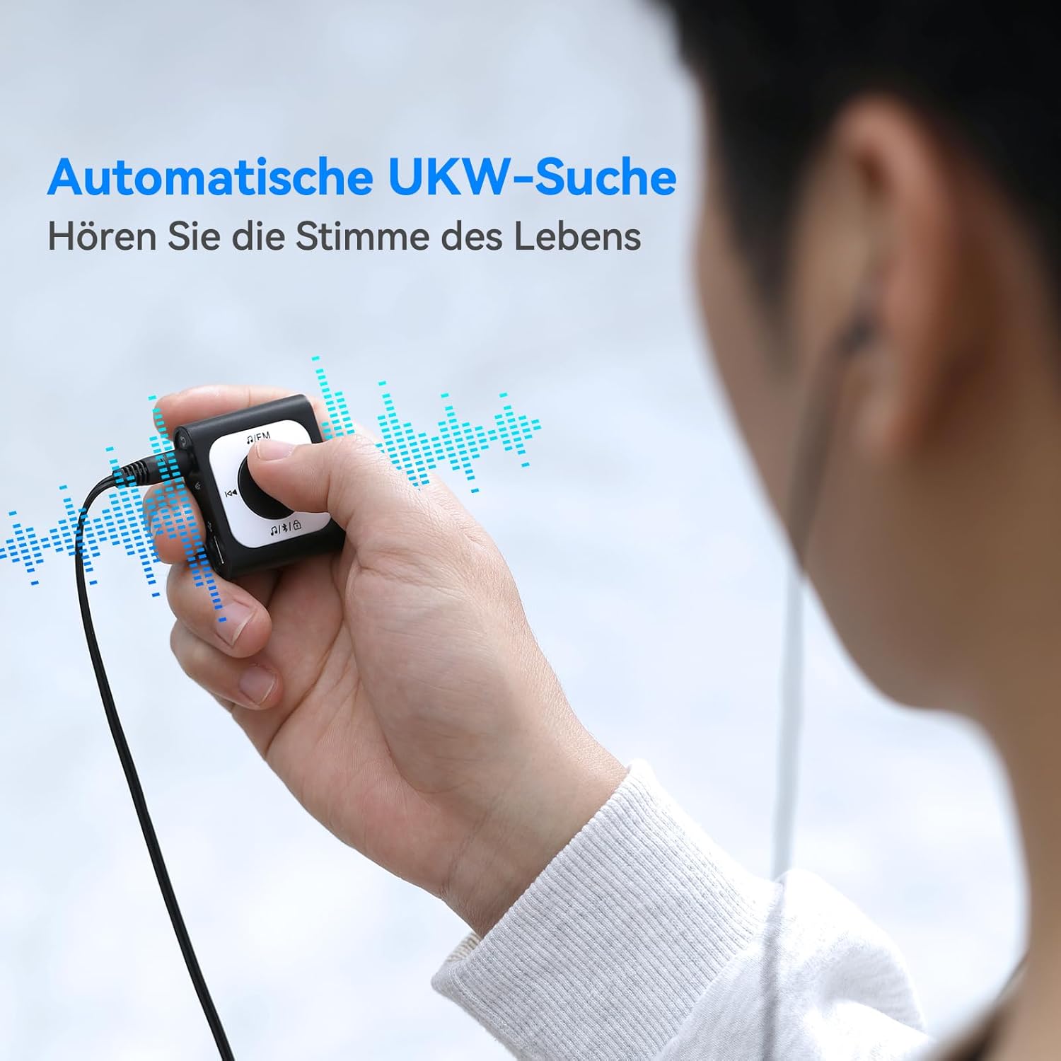 AGPTEK A51PL MP3 Player showing automatic FM search function with wired headphones