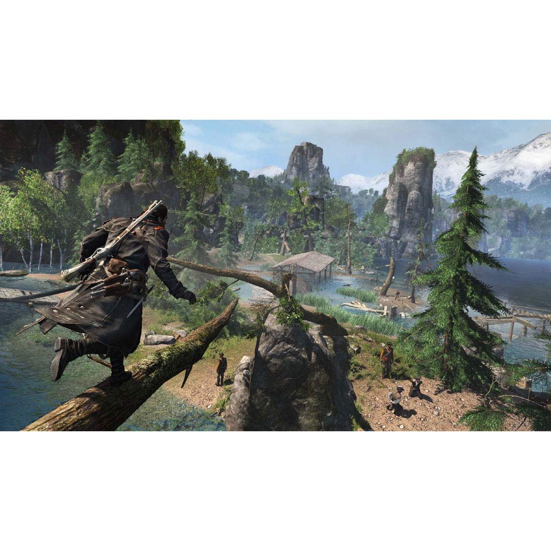 Shay Patrick Cormac balancing on a tree branch overlooking a river valley with mountains in the background.