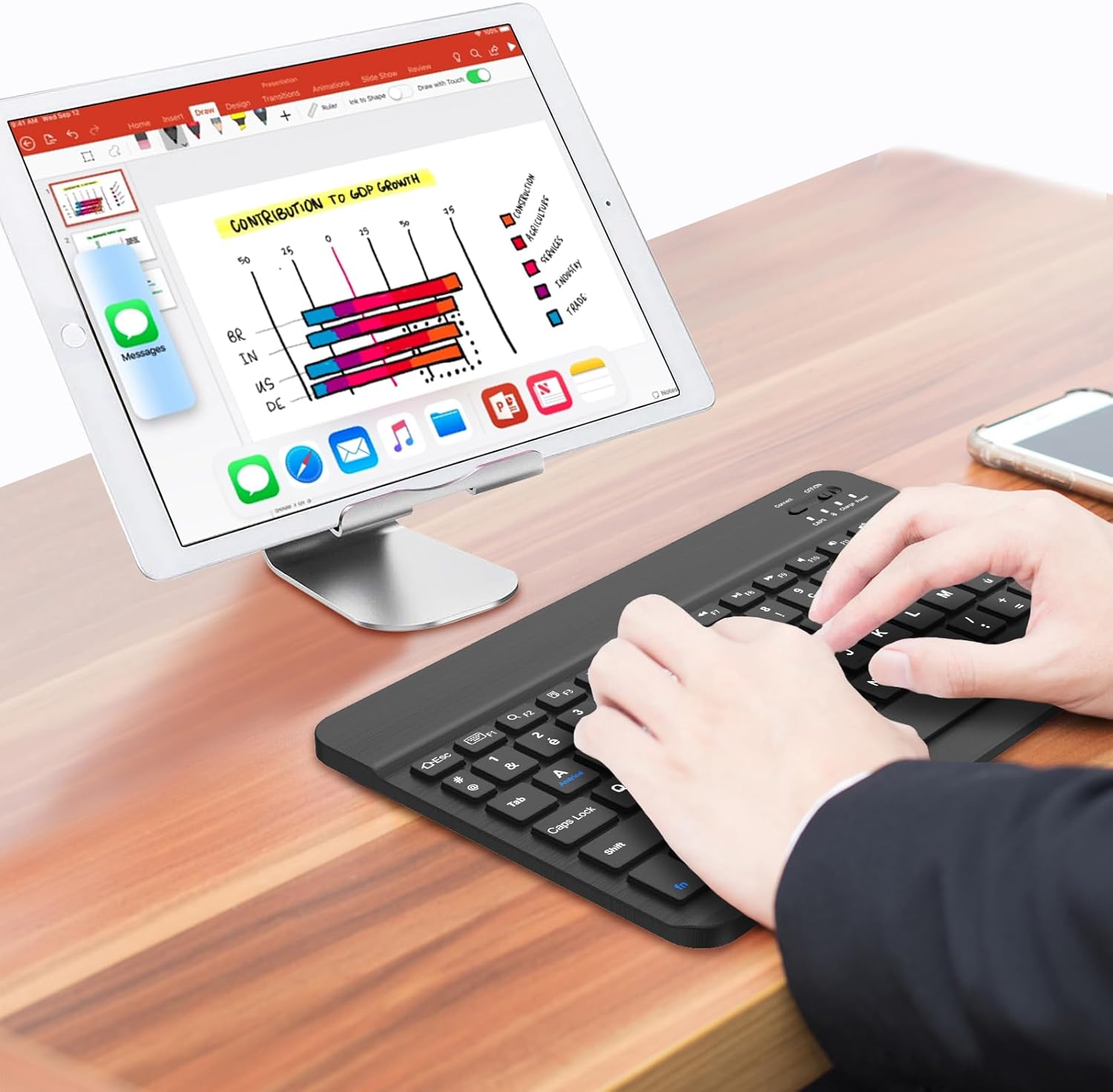 Person typing on the FOGARI wireless keyboard connected to a tablet.