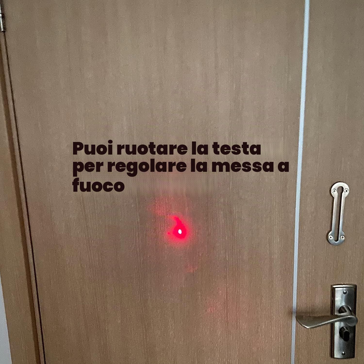 Red laser dot on a wooden door, demonstrating focus adjustment