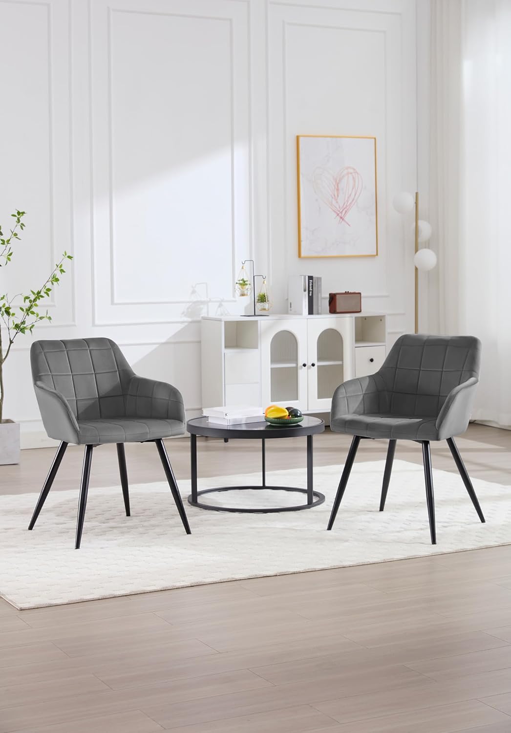 Two WOLTU dining chairs positioned in a living room setting with a small coffee table.