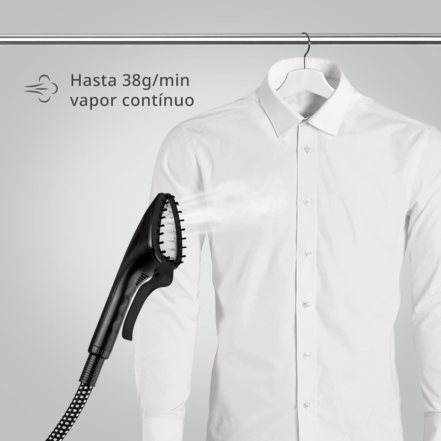 Close-up of the steam head applying steam to a white shirt, showing continuous steam output.