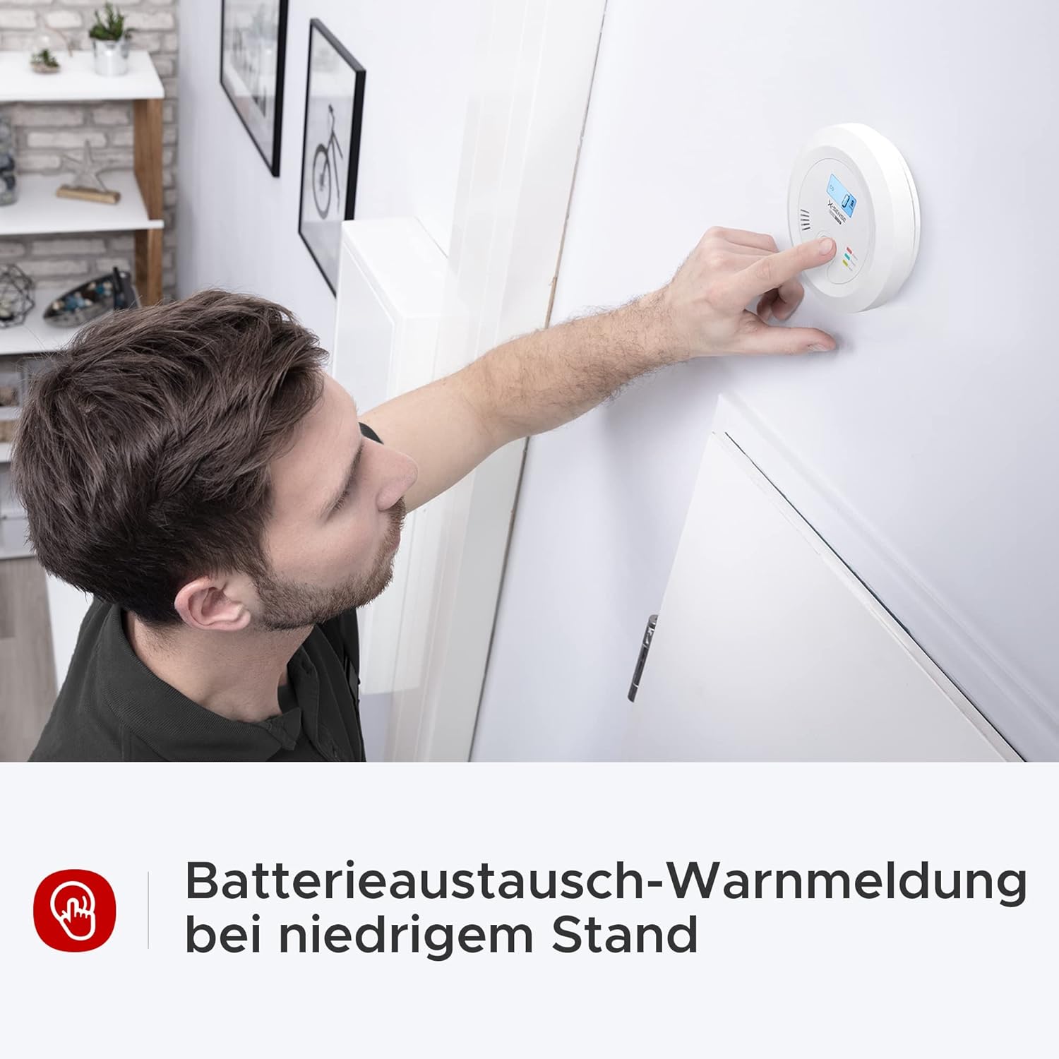 The X-Sense CO03B detector displaying 'Lb' on its LCD screen, indicating a low battery warning.