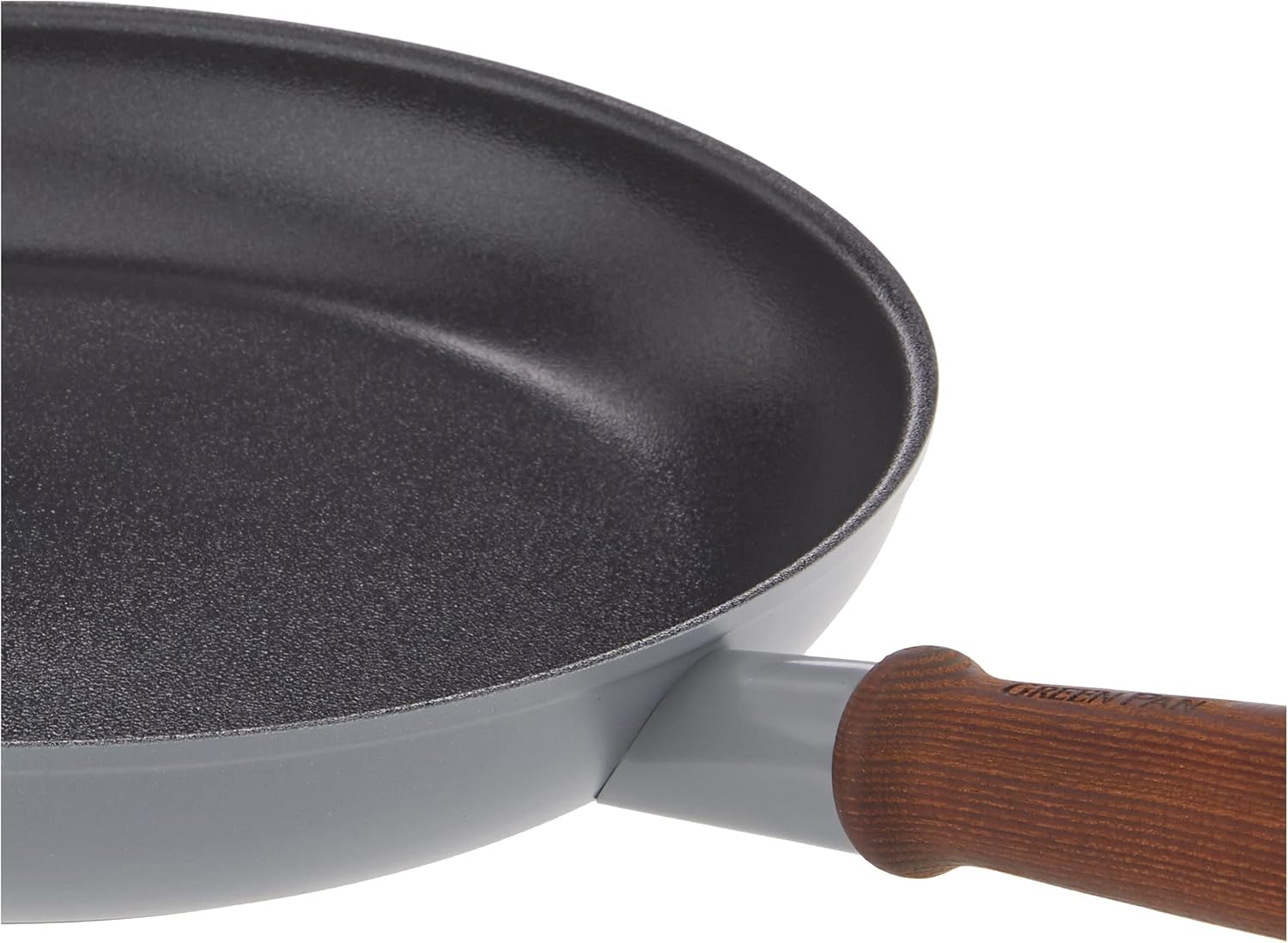 A hand washing a GreenPan Mayflower Pro skillet with soapy water and a sponge, demonstrating the recommended cleaning method.