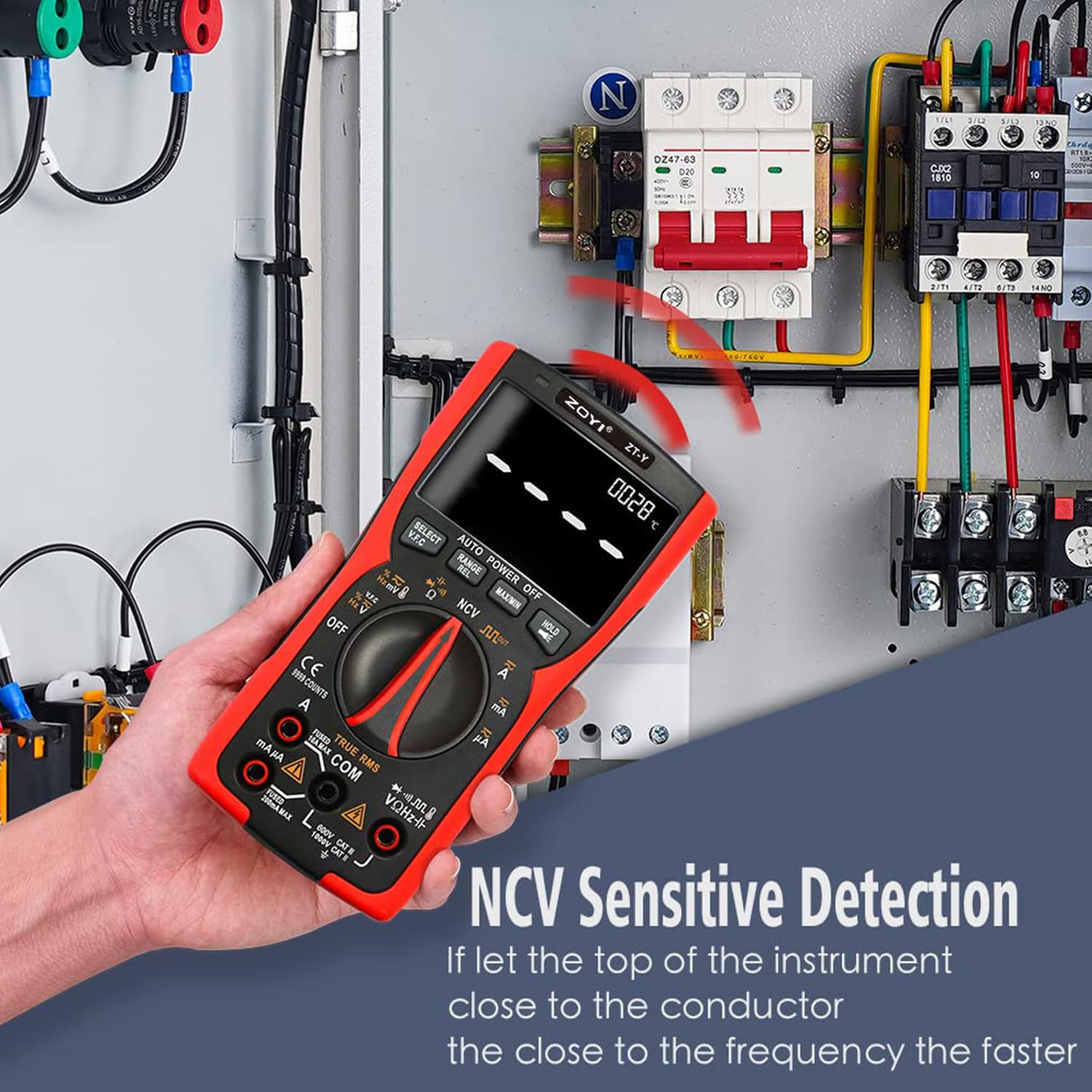 Hand holding ZOYI ZT-Y multimeter near an electrical panel, demonstrating NCV sensitive detection.