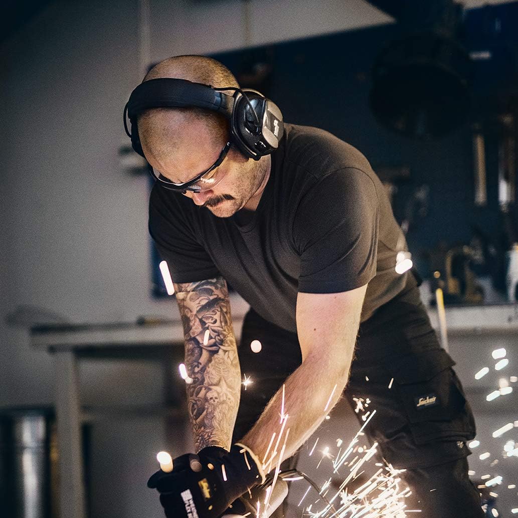 Person wearing Hellberg earmuffs while operating machinery