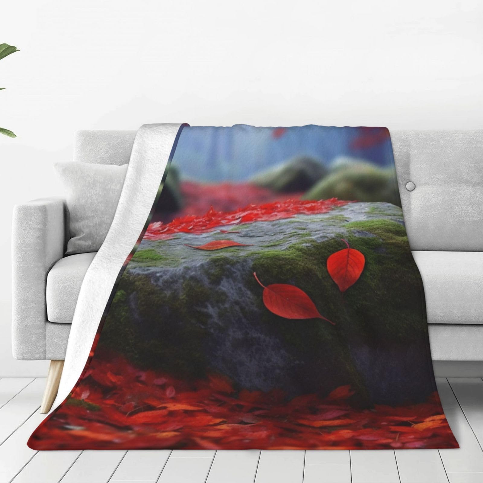 Couverture en micro polaire douce pour cocooning sur le canapé avec motif feuilles rouges