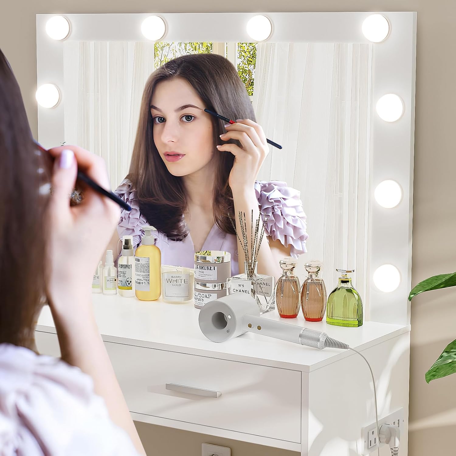 Person using the vanity desk mirror with lights for makeup