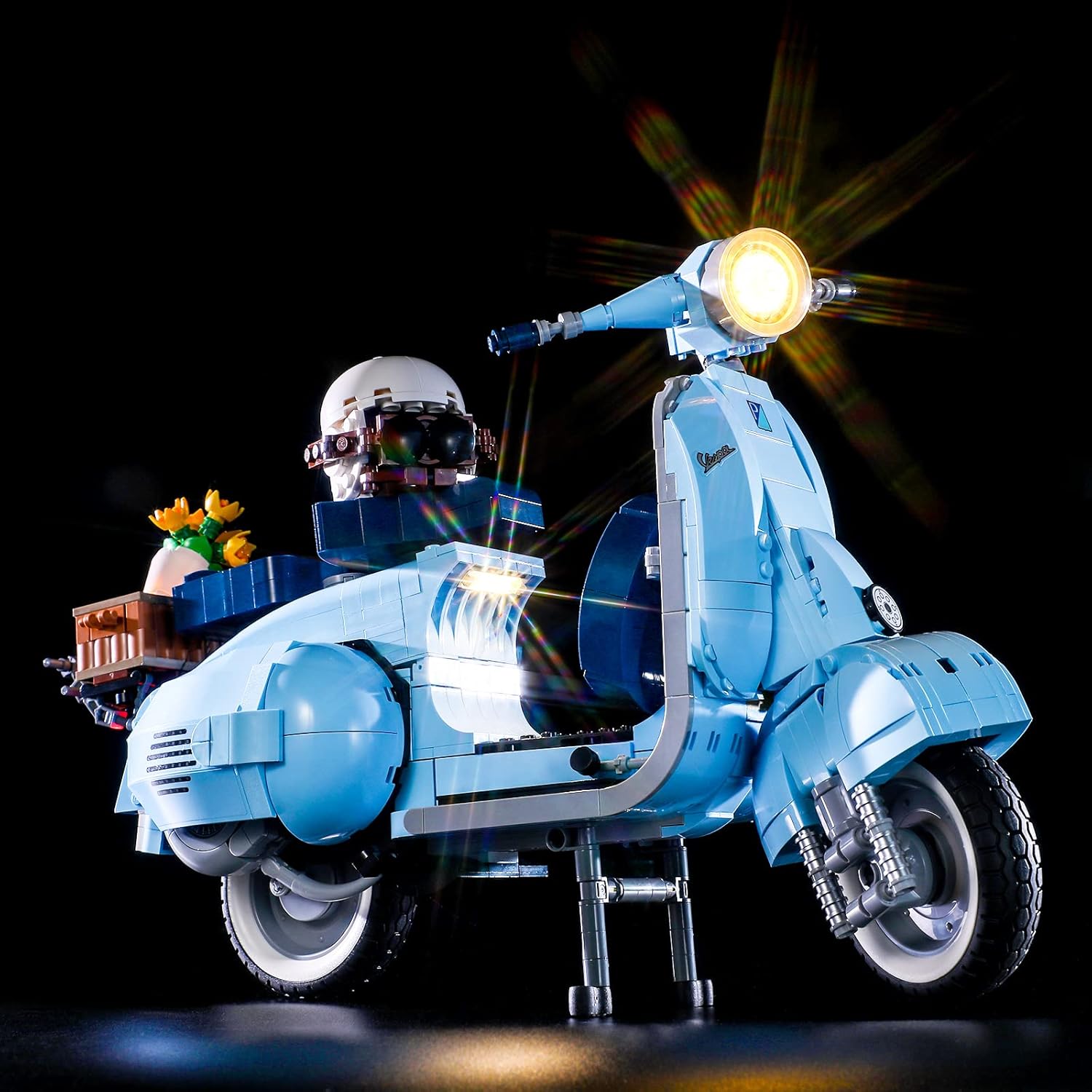 Close-up of the illuminated headlight on the LEGO Vespa