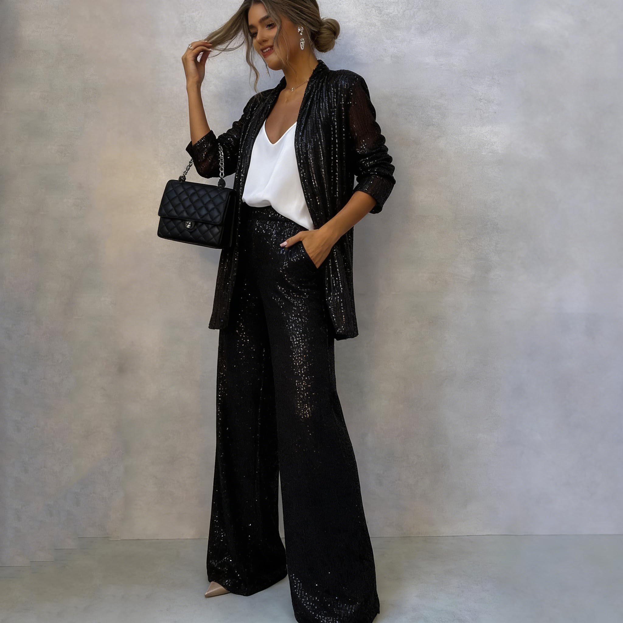 Completo da donna con paillettes composto da un elegante blazer con scollo a V e pantaloni a vita alta e gamba larga, un scintillante completo da festa in due pezzi.