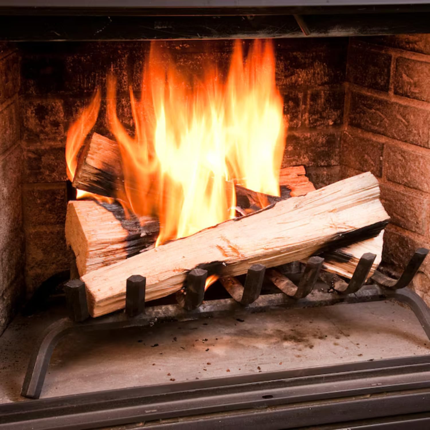 Hand lighting a Duraflame Quick Start Firelighter in a fireplace