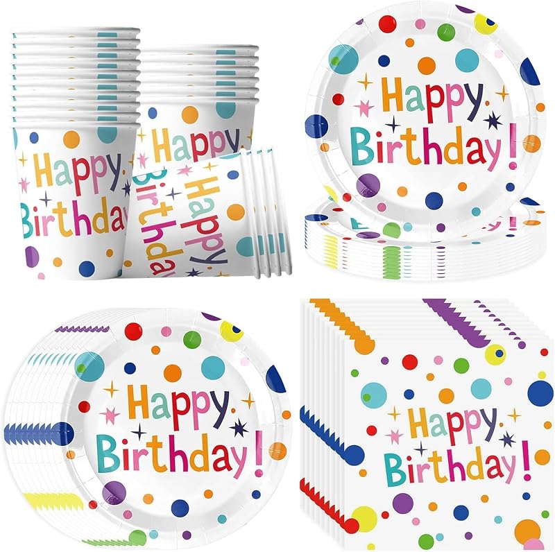Vajilla de cumpleaños con lunares de colores. Vajilla desechable de fiesta con lunares de colores sobre una mesa de cumpleaños