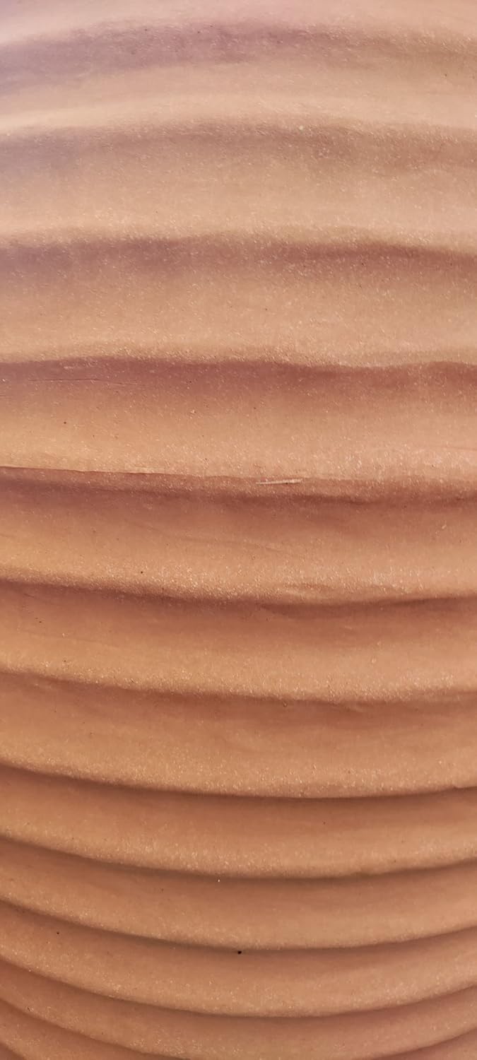 Close-up of the ribbed texture of the Sankey Beehive Water Butt, showing the detail of its terracotta-like finish.