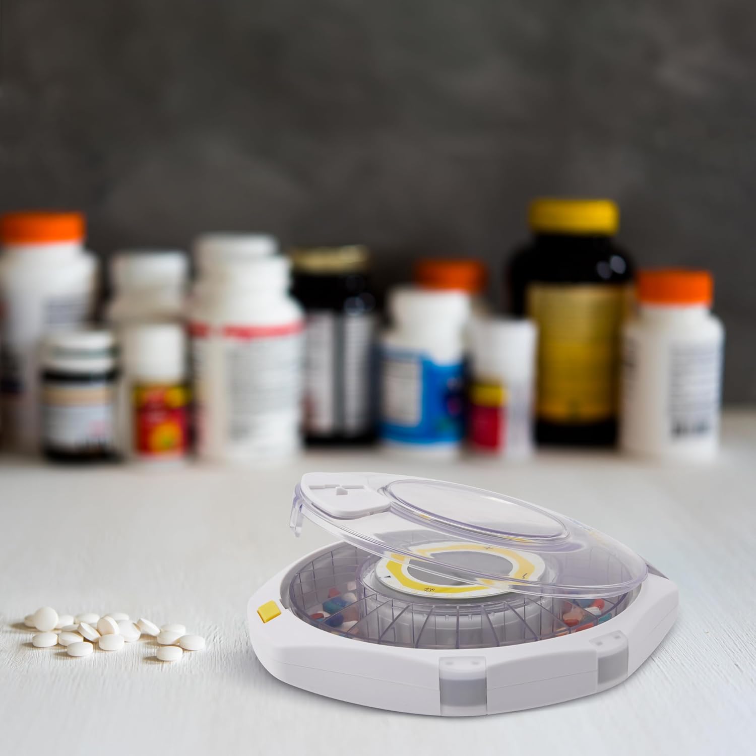 Pill dispenser with lid open, showing compartments and dosage ring