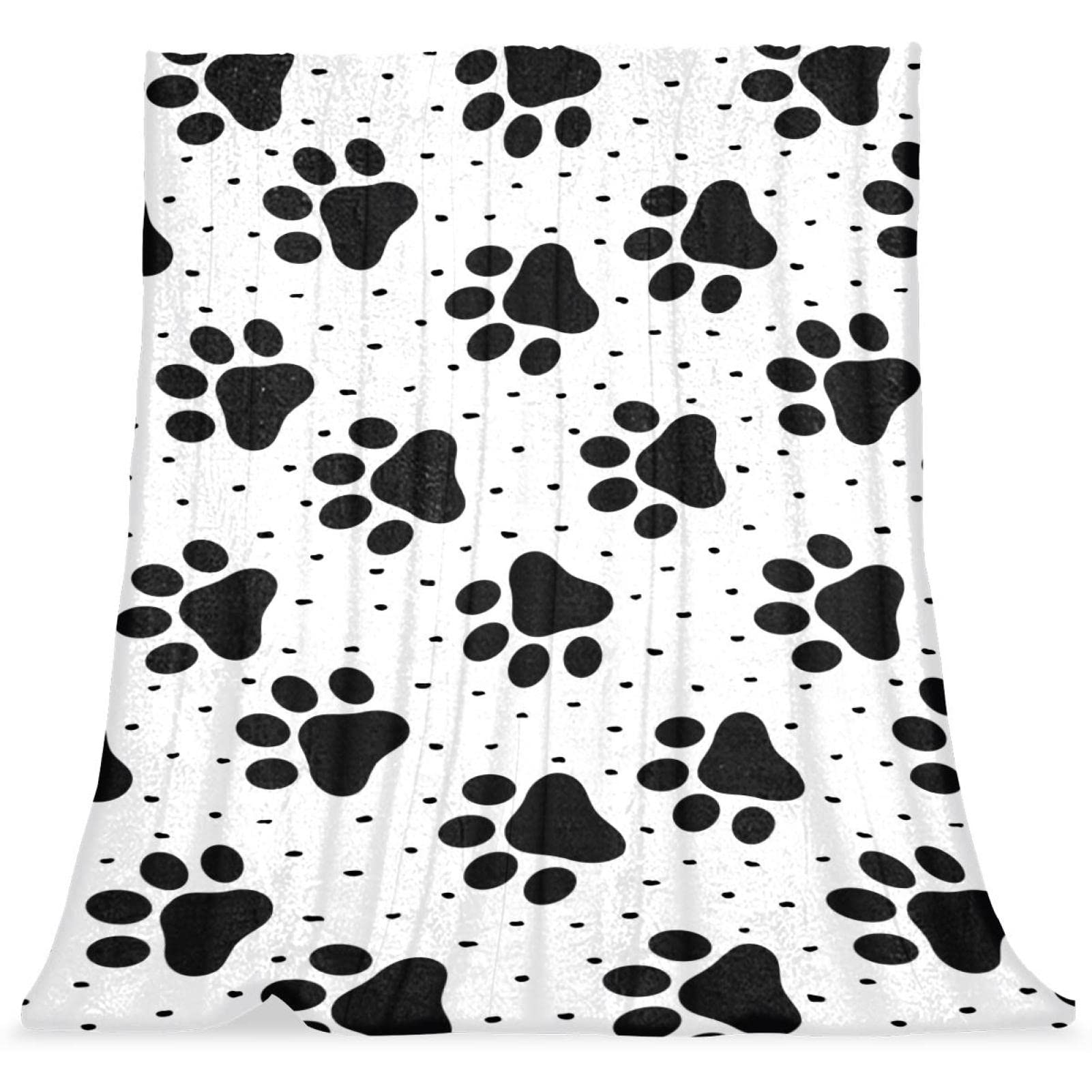 Motif de patte de chien noir sur couverture en peluche anti-froid