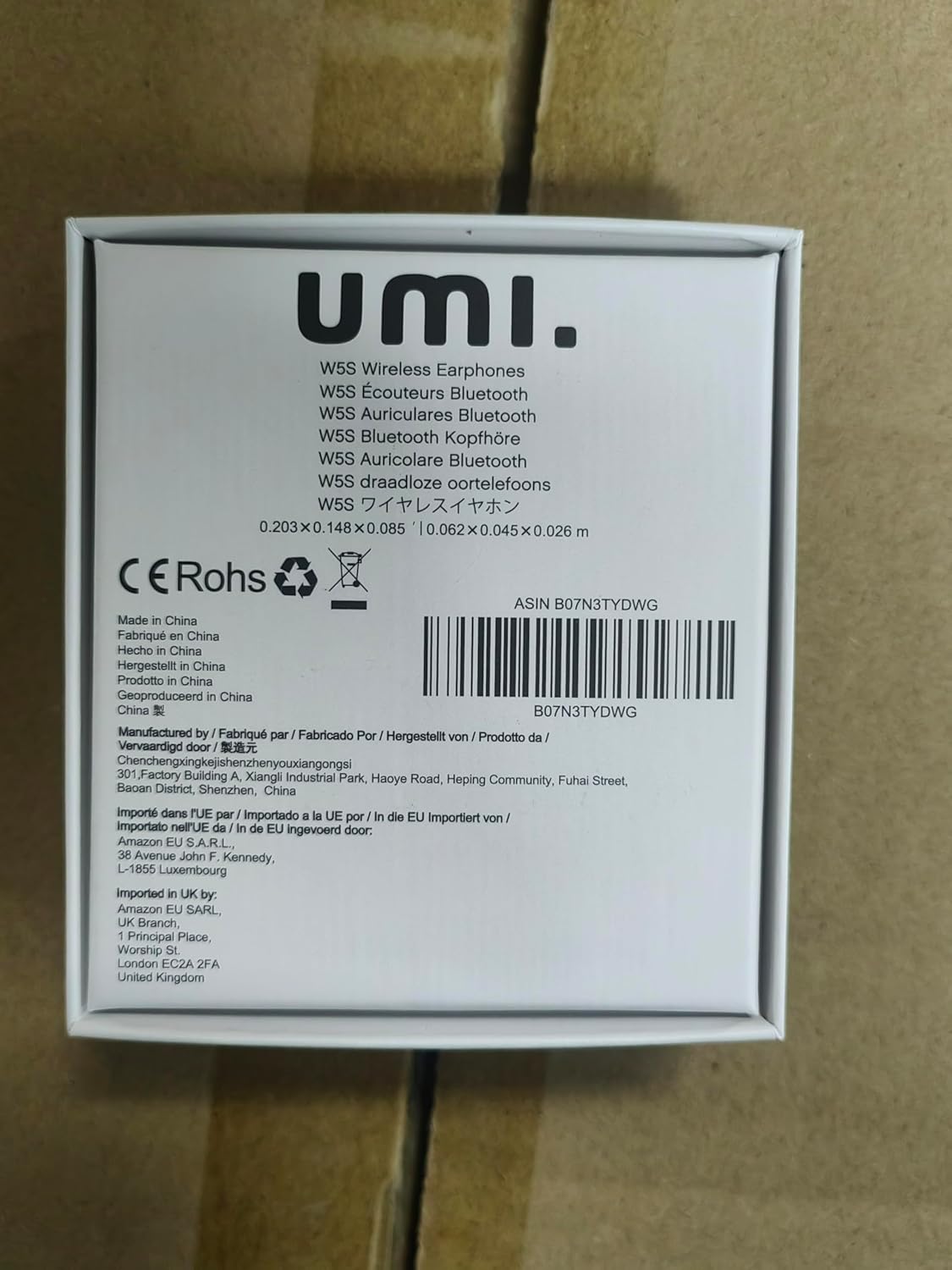 Voltar view of the Umi W5s wireless earbuds and their charging case.