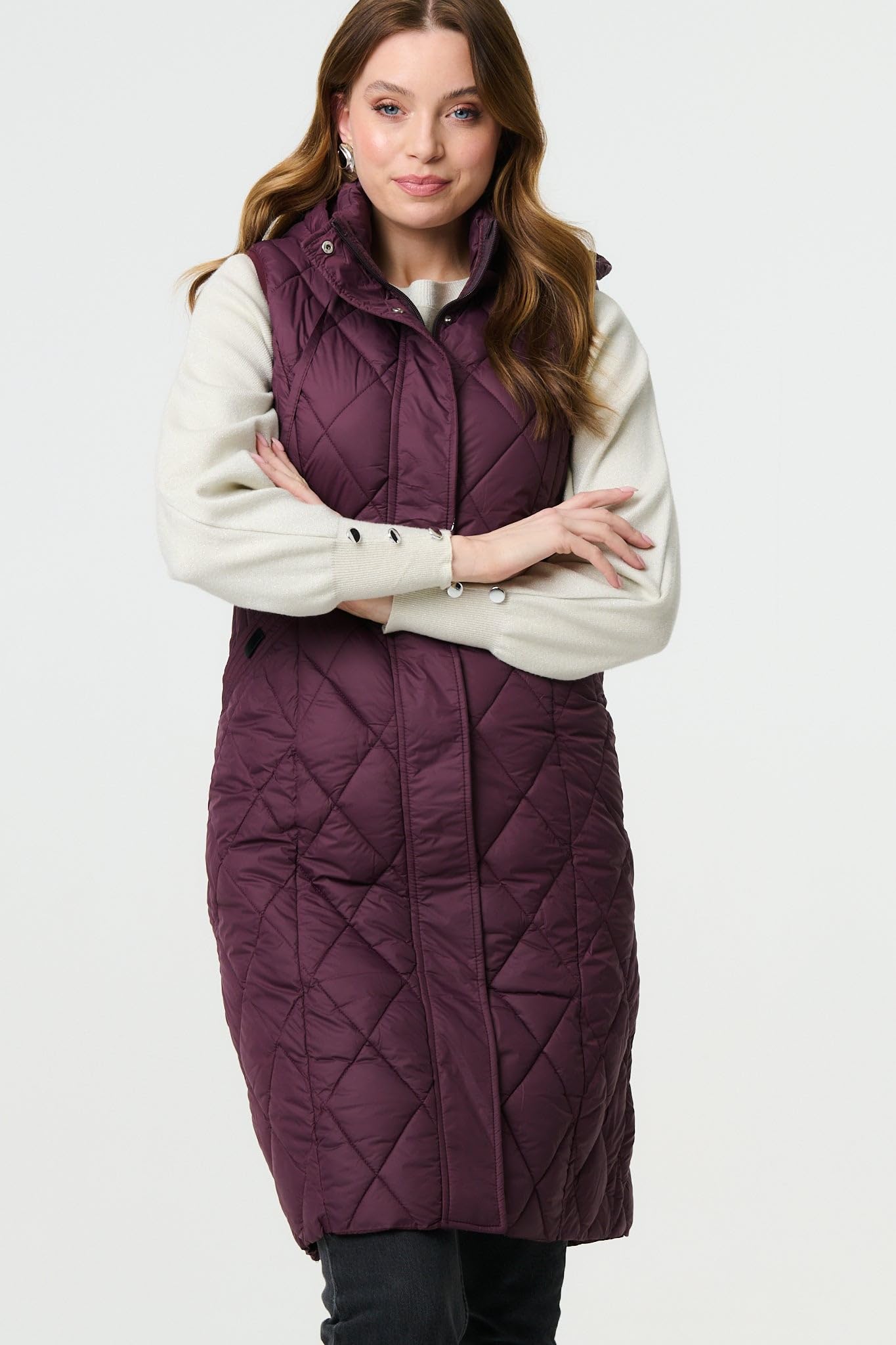 Izabel London Hooded Sleeveless Longline Puffer Gilet For Women UK with a front zip, a hood and pockets.