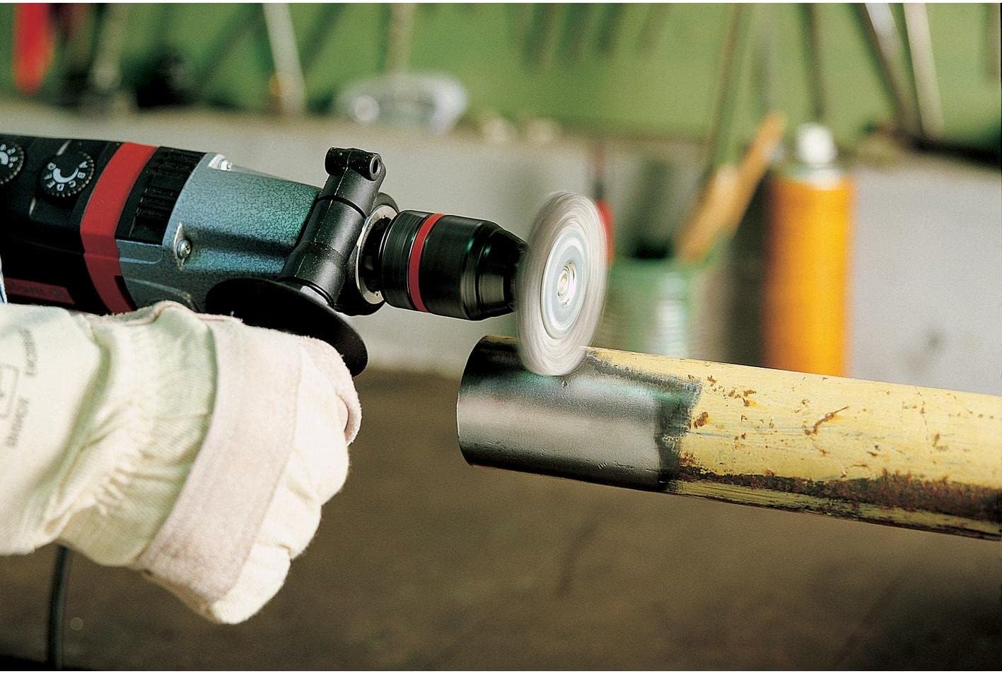 Wire brush cleaning a metal pipe
