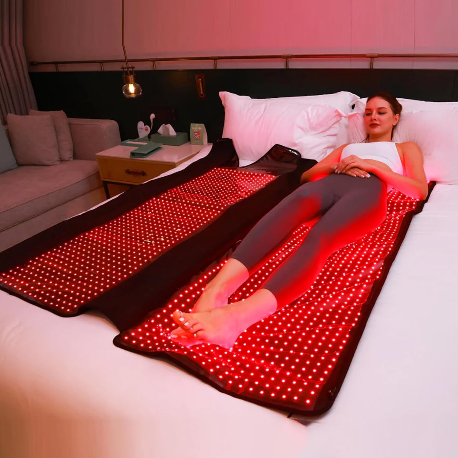 Woman using the MEGELIN red light therapy mat for full body treatment