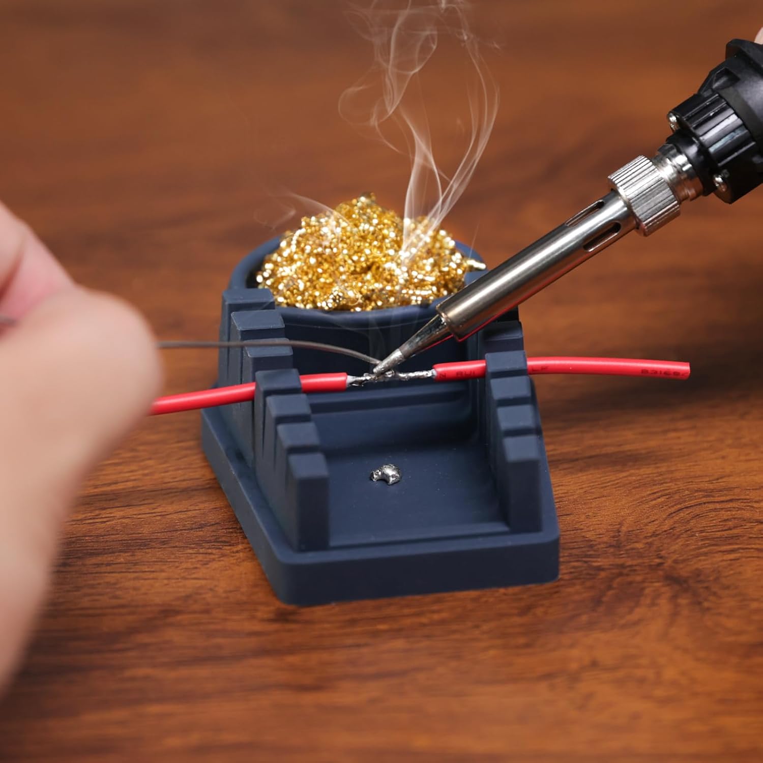 Person soldering wires held securely in the WEP S200 wire holder