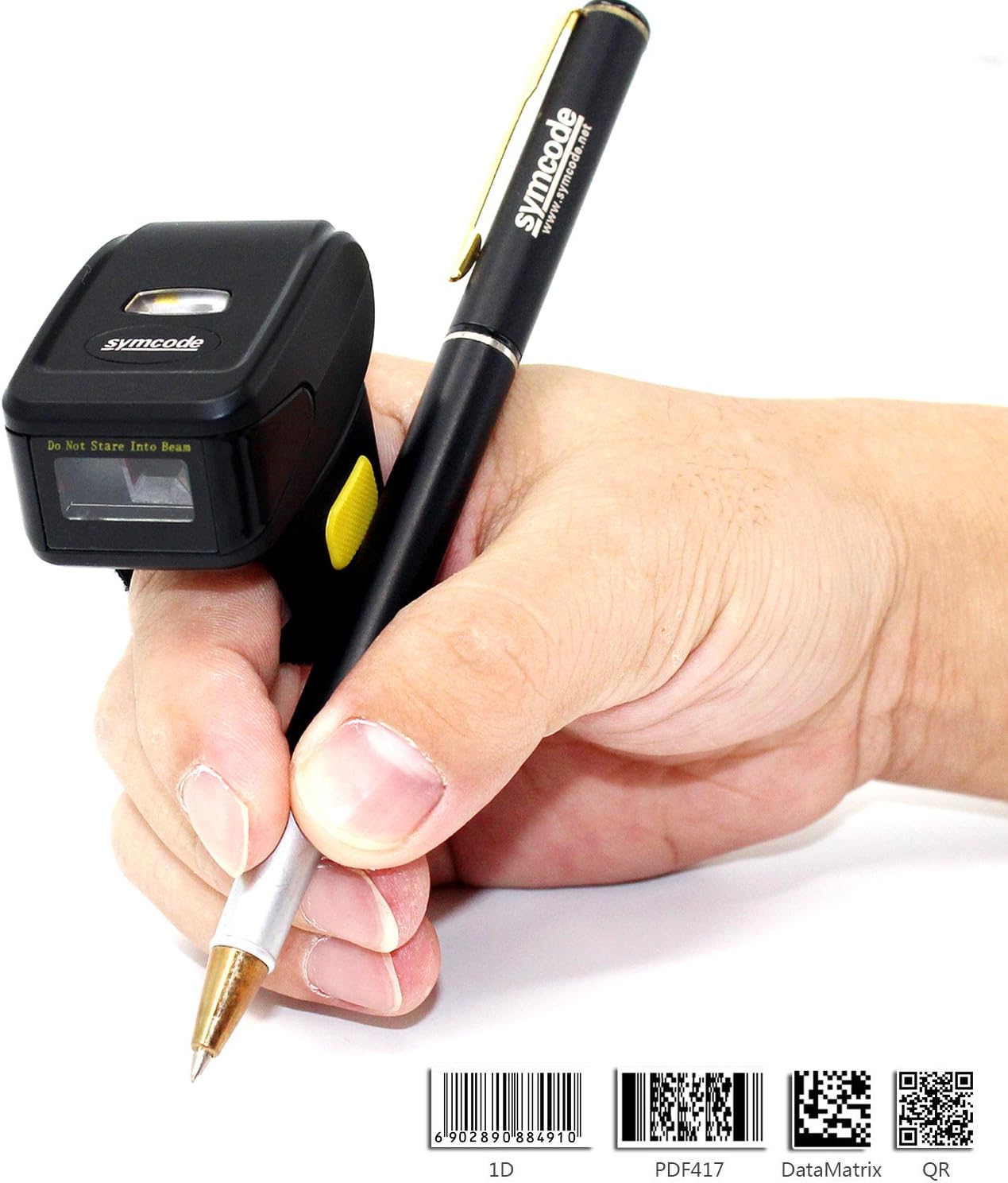 A hand wearing the Symcode ring barcode scanner and holding a pen, demonstrating its ergonomic design