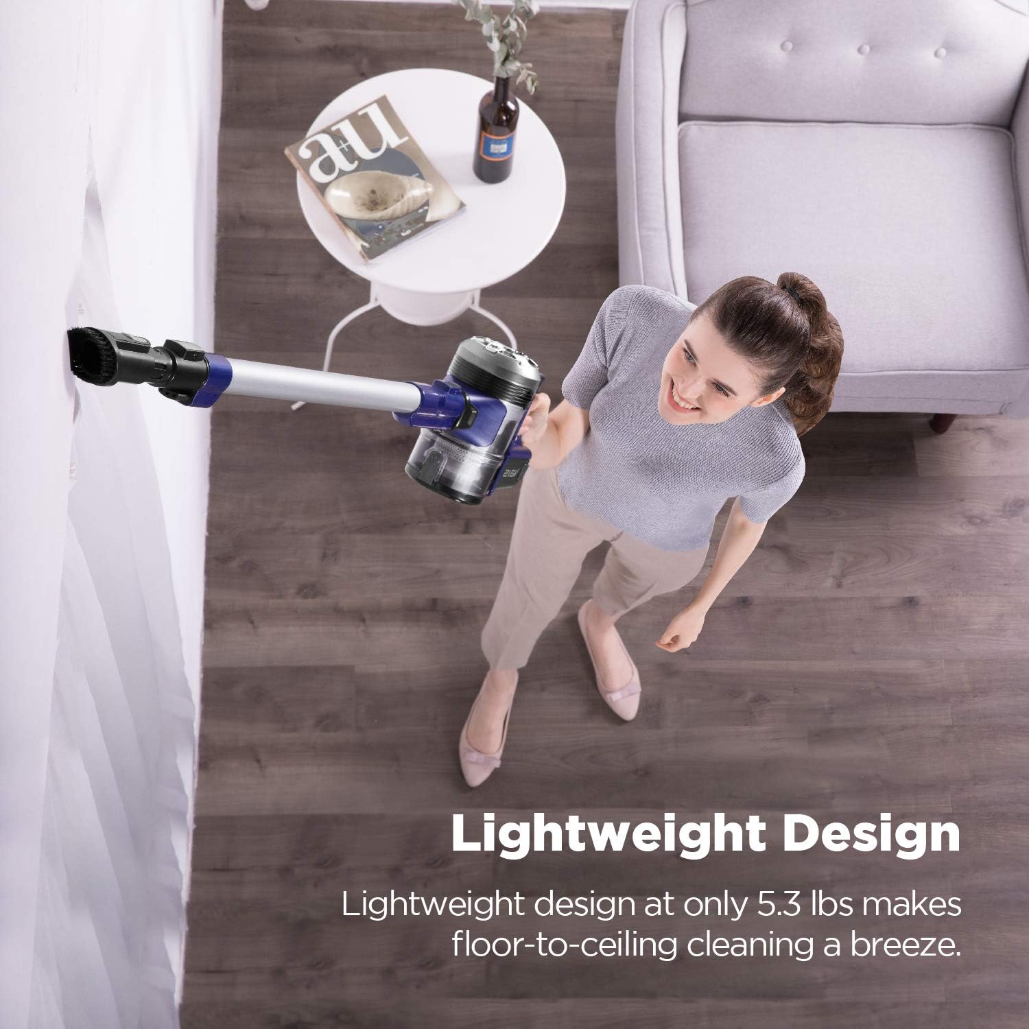 Woman using the lightweight Eureka NEC122 vacuum to clean a high corner