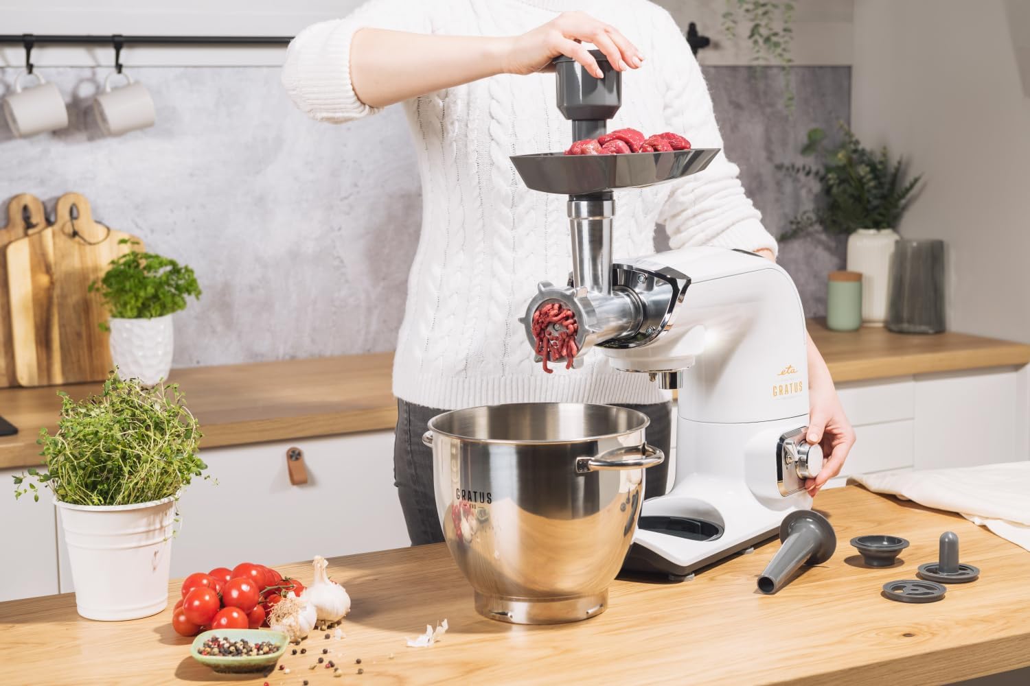 Meat grinder attachment in use, grinding meat