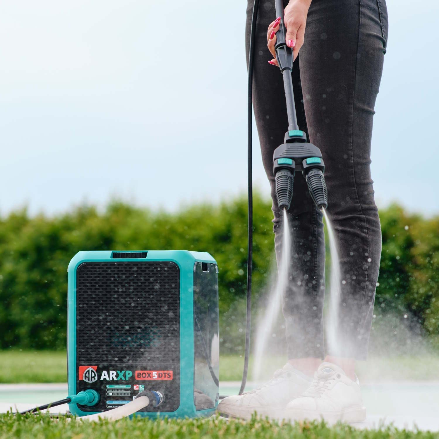 Person using ARXP BOX5 160DTS with Twin Nozzle accessory for wider cleaning.