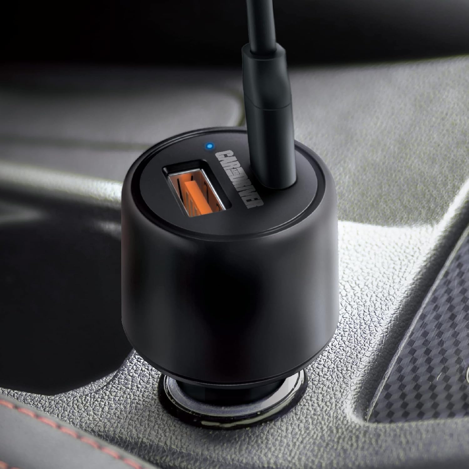 Close-up of the Car and Driver Dual-Port Car Charger with a blue LED indicator light on, showing a cable plugged into the USB-A port.