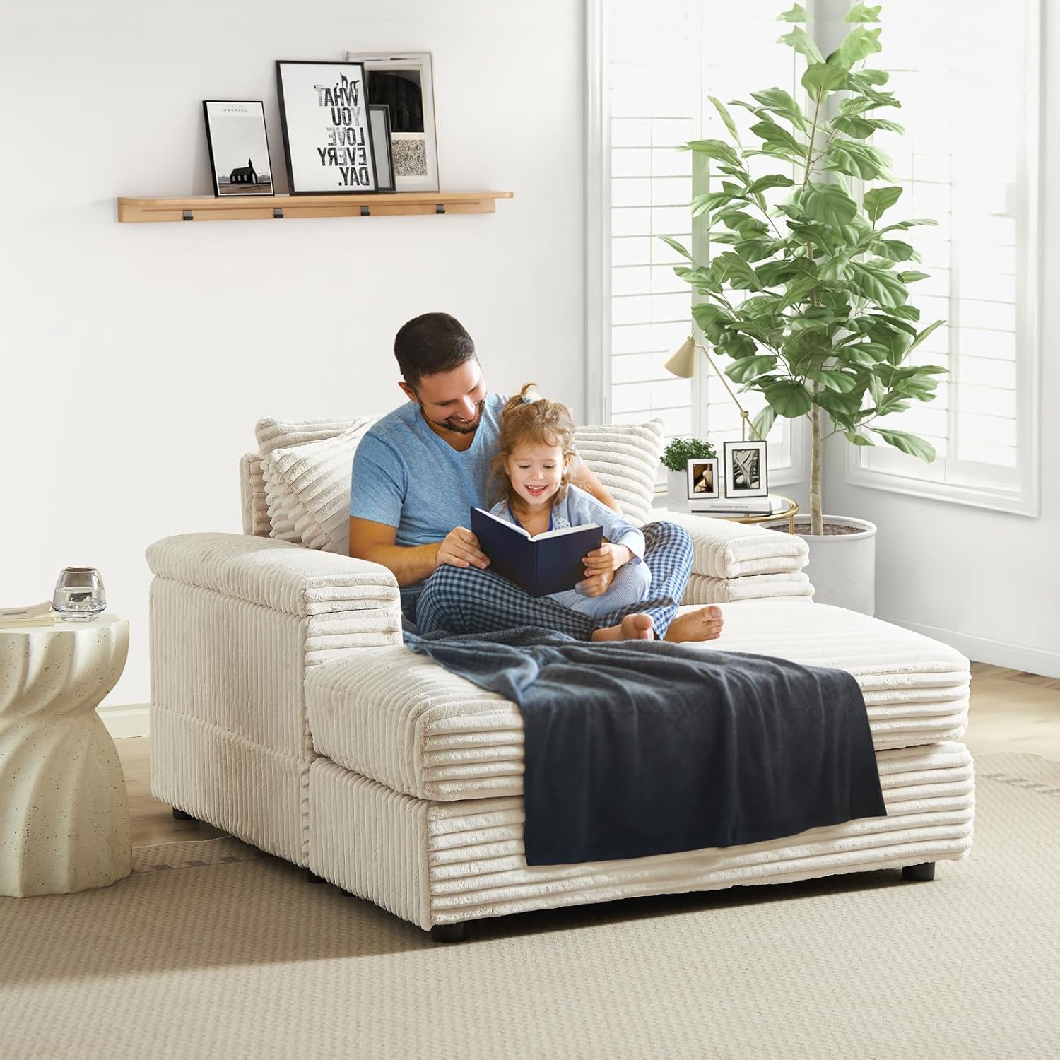 Father and child sitting comfortably on the chaise lounge