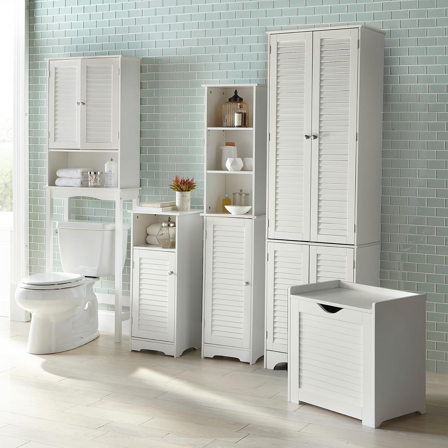 Multiple BrylaneHome Louvre cabinets in a bathroom setting, including the tall cabinet, linen cabinet, and hamper.