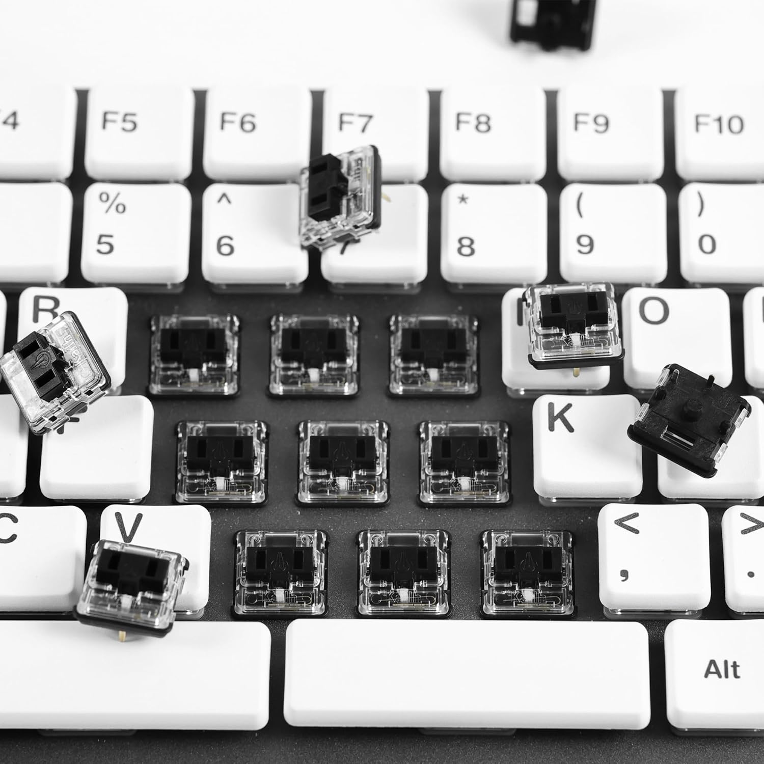 Kailh PG1350 Choc V1 switches being installed or removed from a mechanical keyboard.