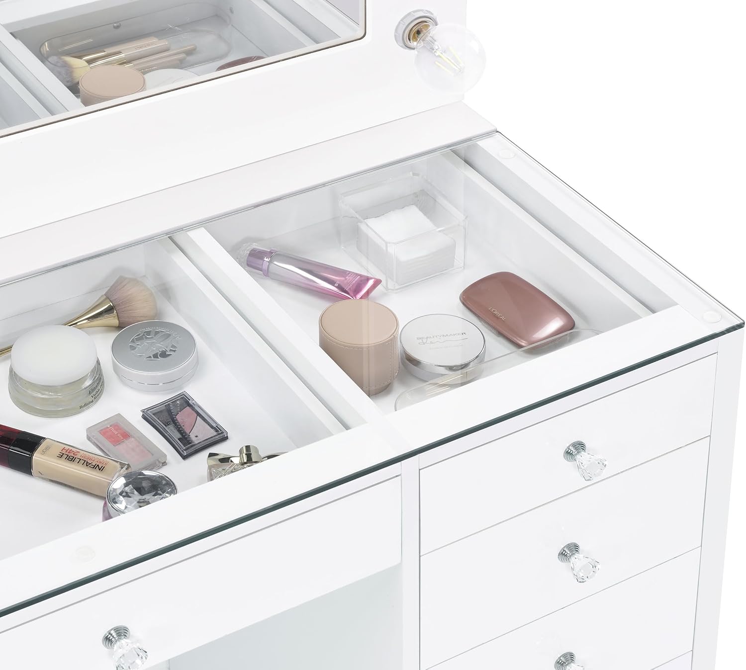 閉じる view of the clear tempered glass top of the vanity desk, showing organized cosmetics and beauty products beneath.