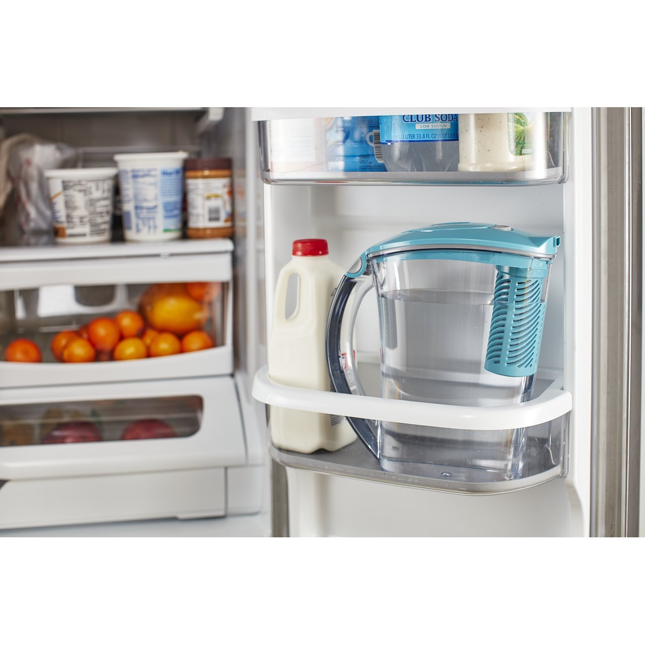 Person pouring filtered water from Brita pitcher into a glass