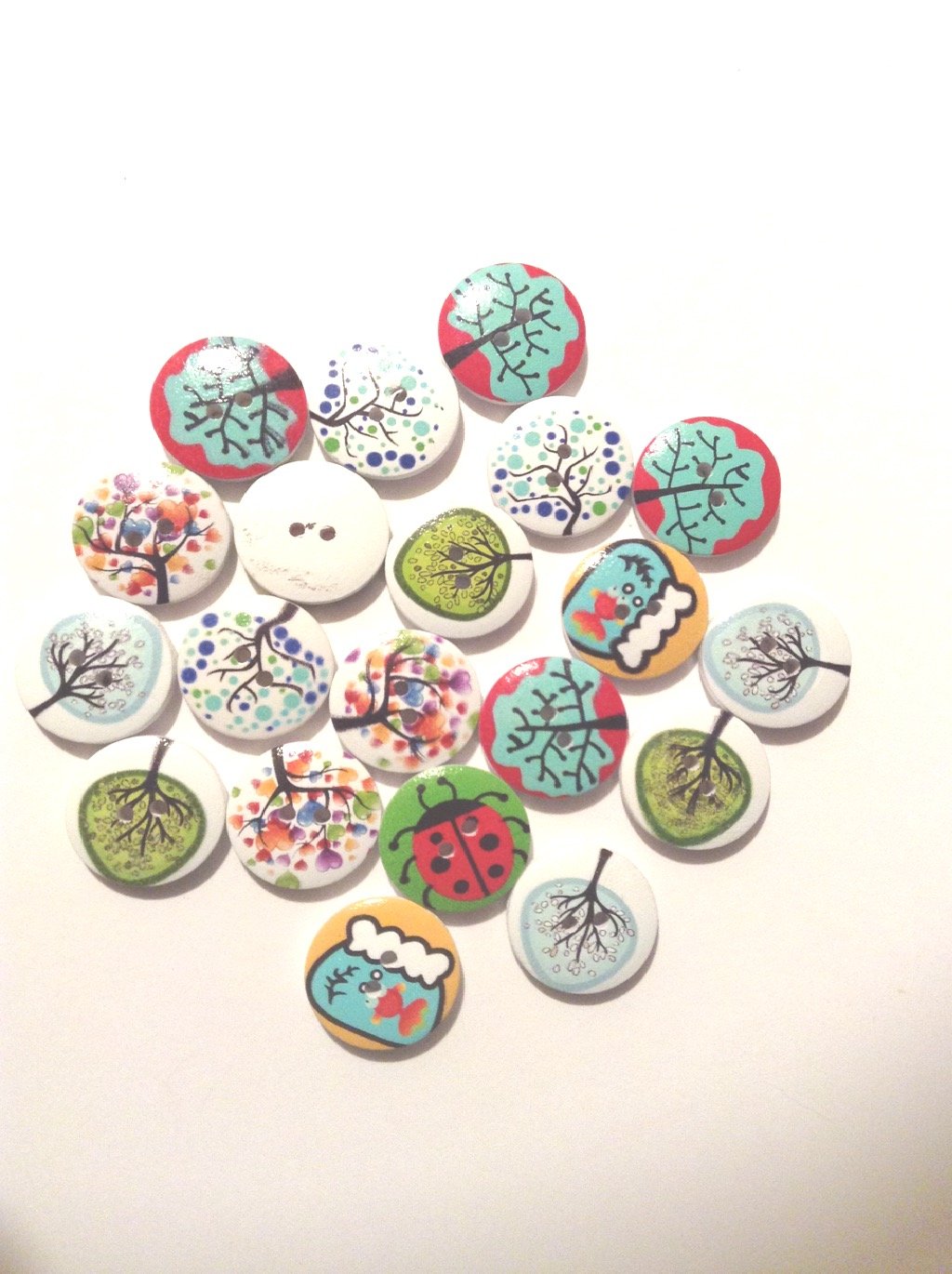 Tree Patterned Buttons with a White Back and Two Holes. These Buttons Have a Mix of Patterns but All Have a Tree Theme to Them. The Pack Contains 10 Buttons which are Approx 20mm