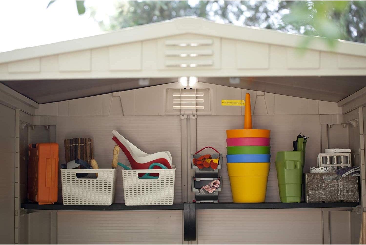 Interior view of the shed with various garden items
